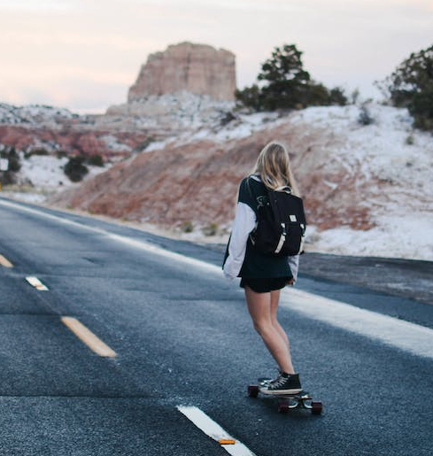 woman skateboarding on highway